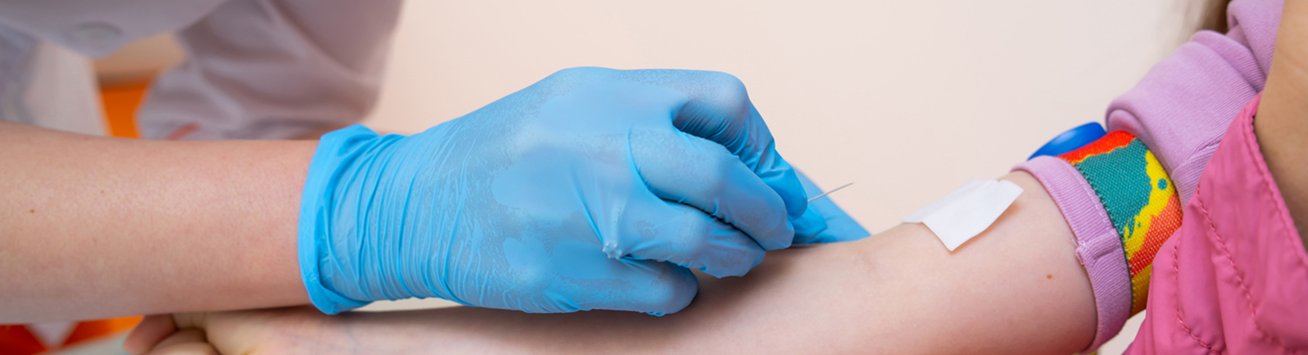 phlebotomist drawing a child's blood 